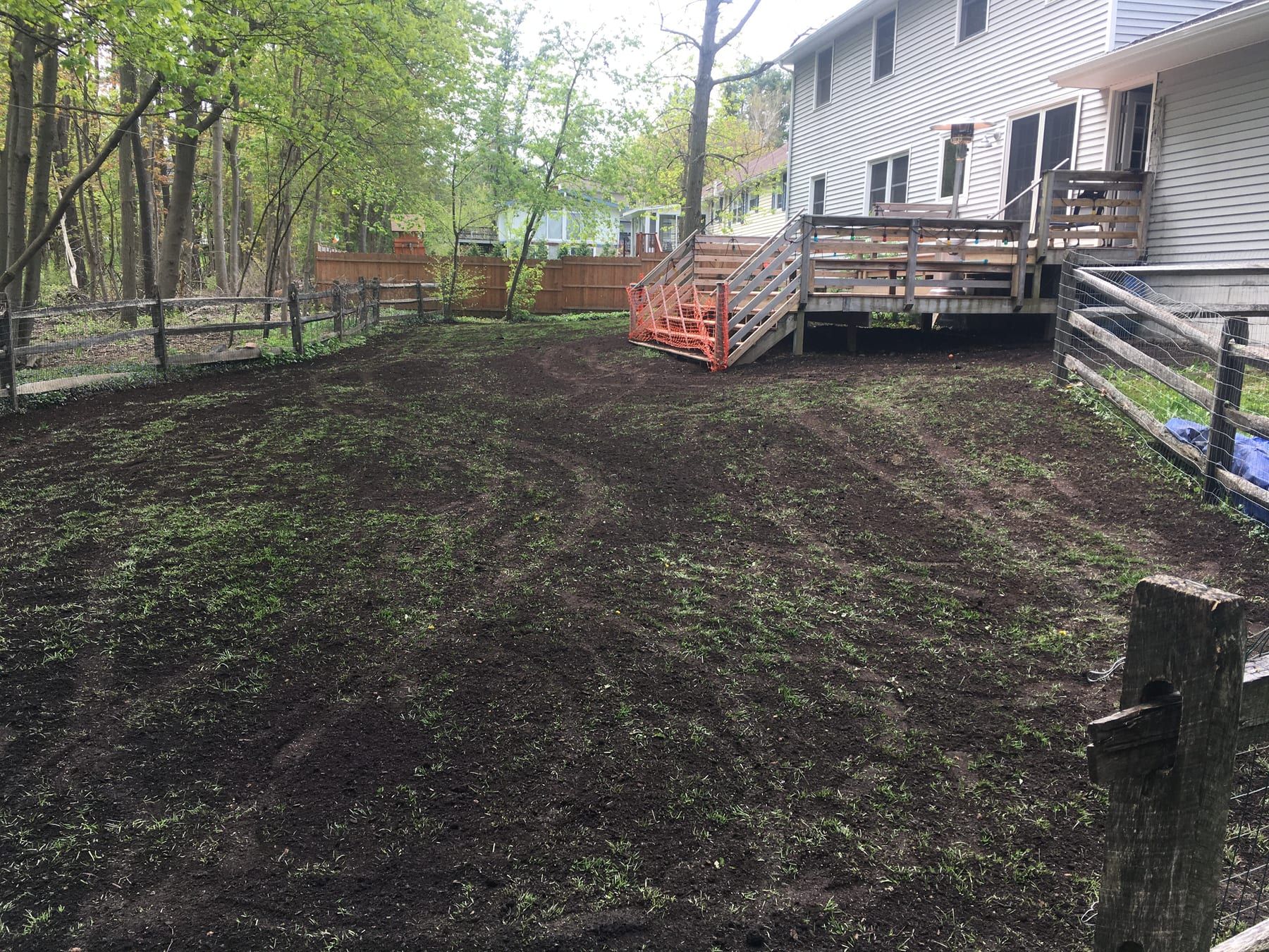The same backyard as bare seeded soil in early May