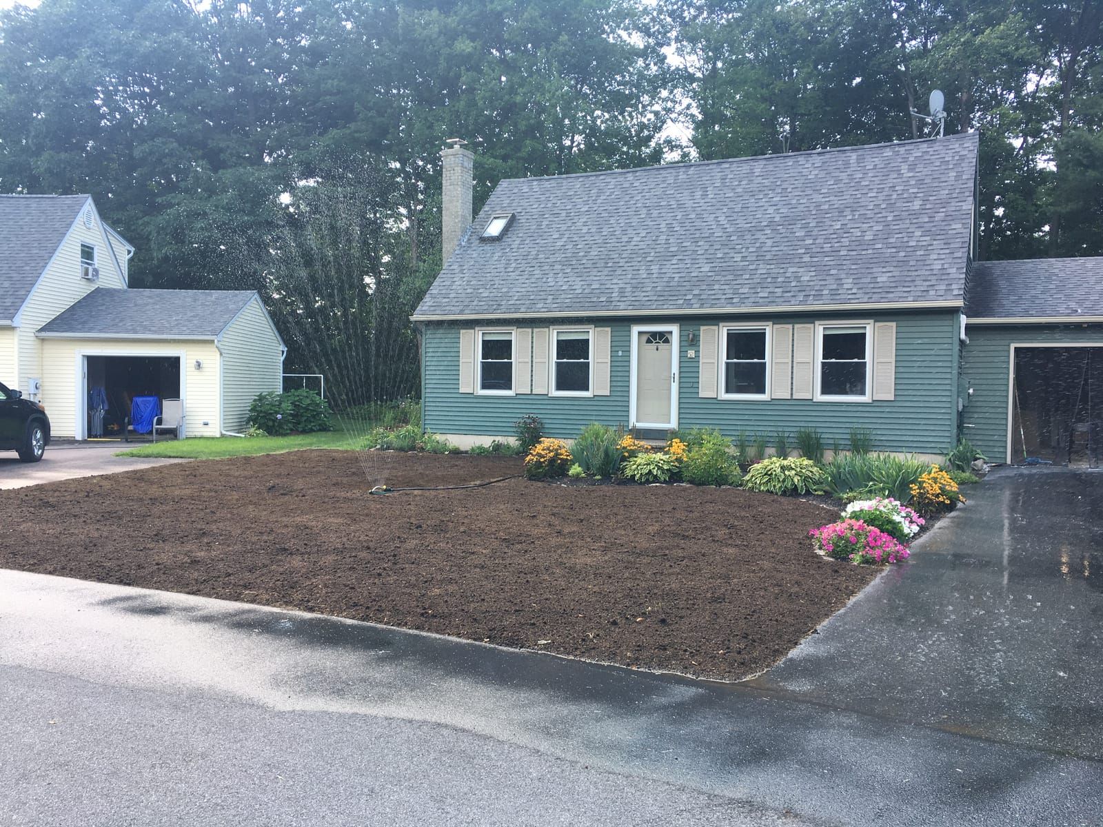 Fresh front beds planted along a Cape house
