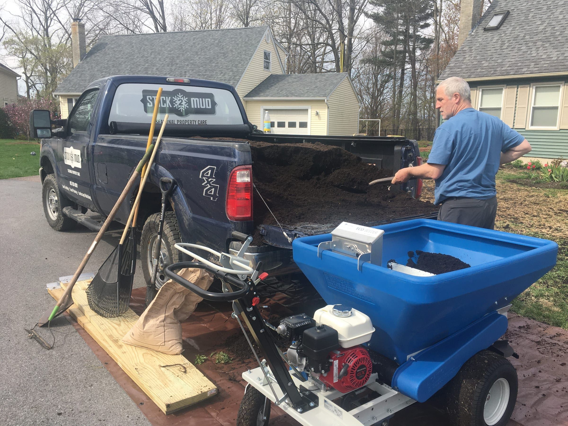 Keith loading the compost topdresser onto the Stick2Mud truck