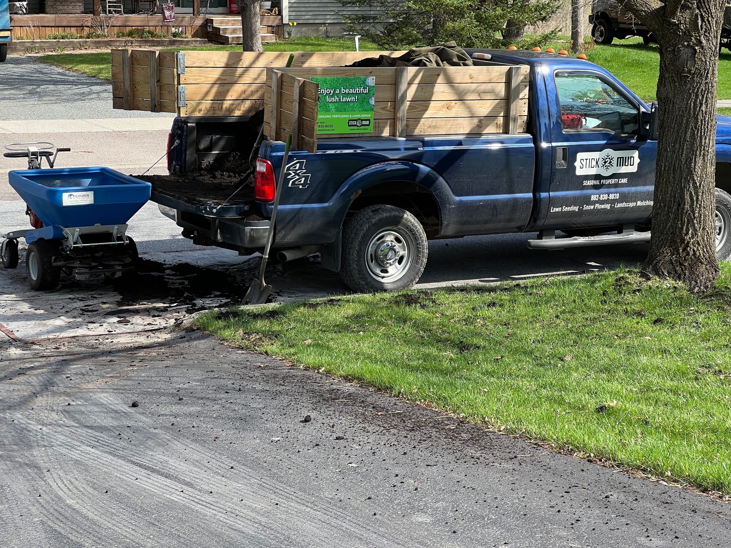 The Stick2Mud truck beside a lawn with the topdresser loaded on the back